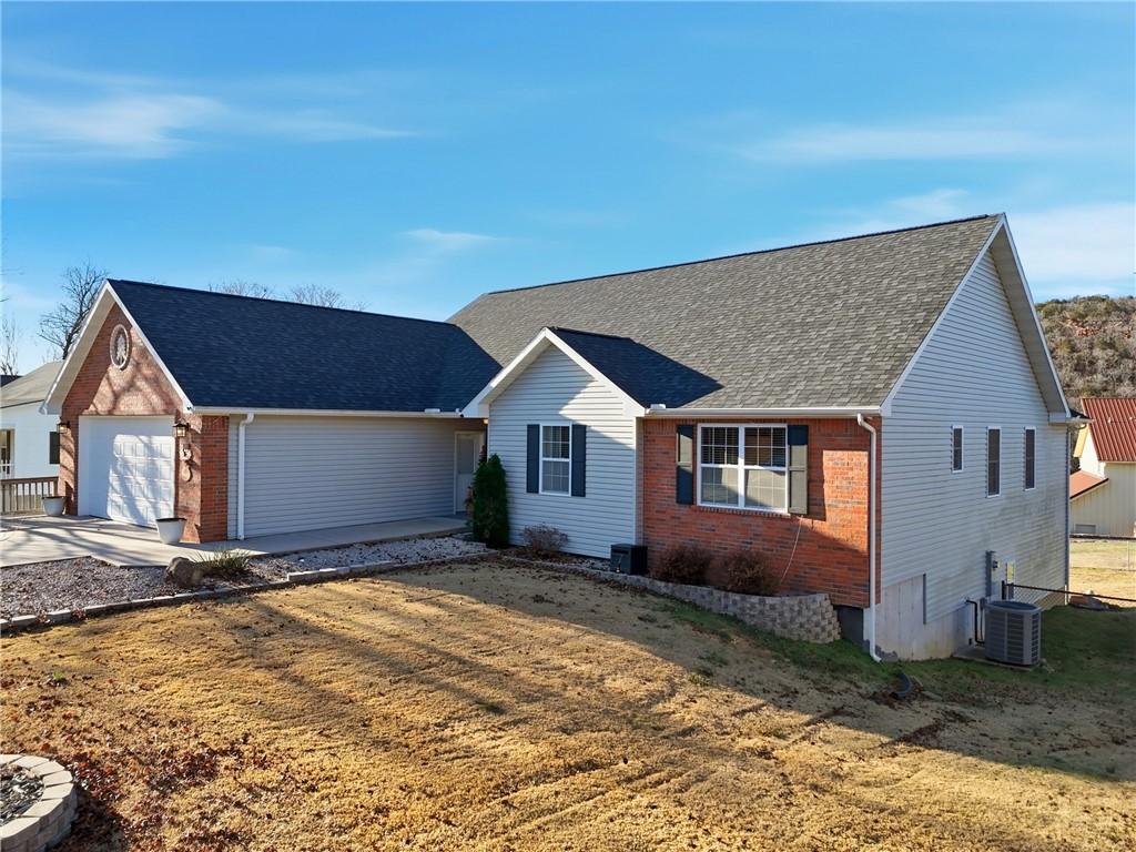 Image 2: Ranch-style home featuring brick siding, roof with