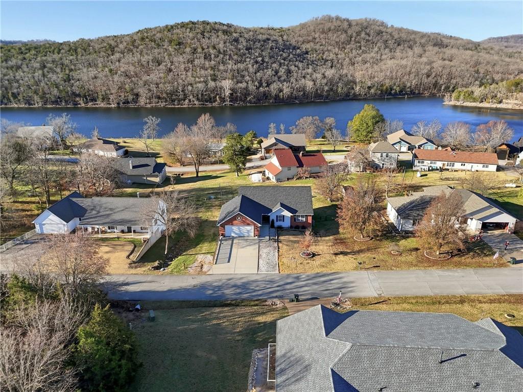 Image 3: Aerial view of residential area with a heavily woo