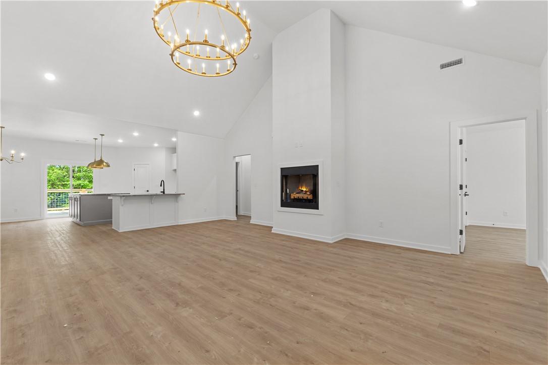Image 3: Open concept living space featuring vaulted ceilin