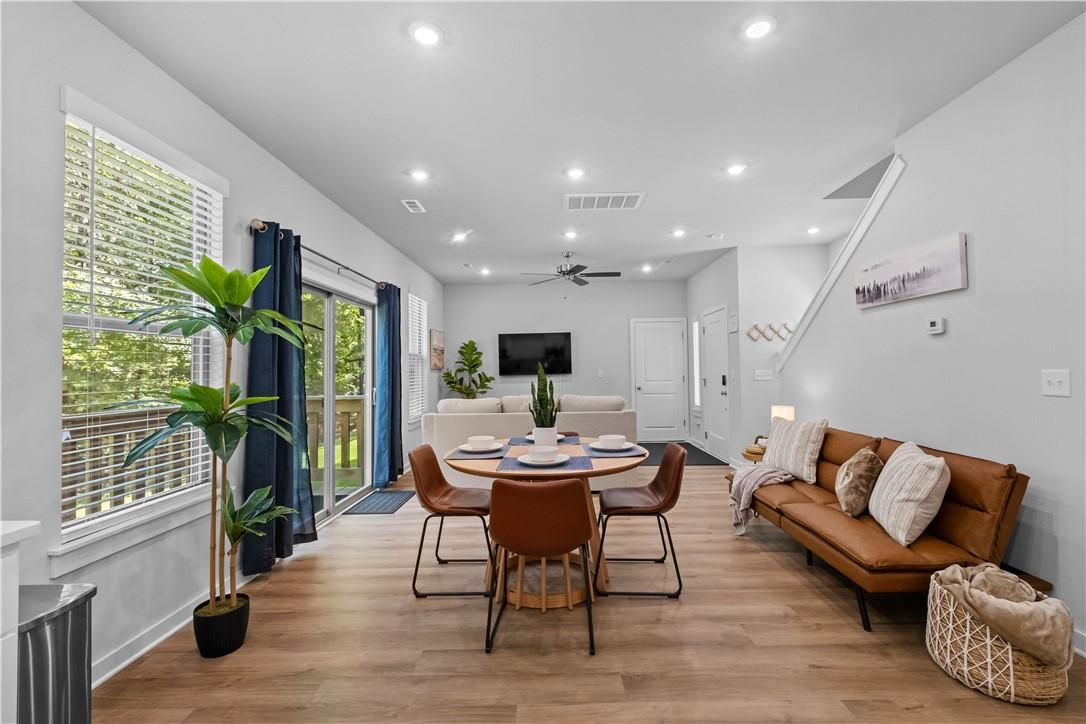 Image 4: Open-concept living area featuring wood-finish flo
