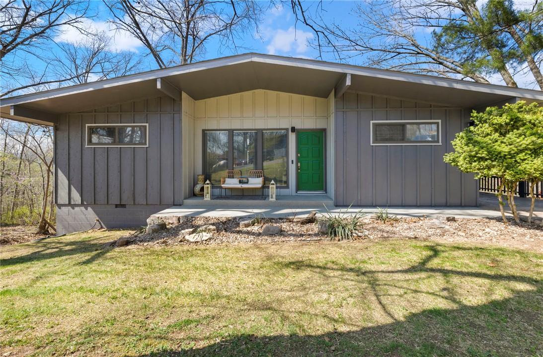 Image 2: Property entrance with a yard and board and batten