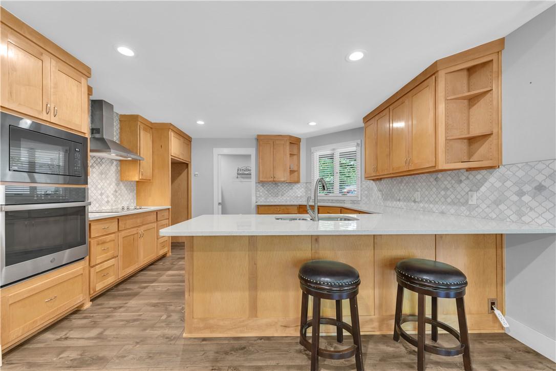 Image 2: Contemporary kitchen featuring wood-finish cabinet