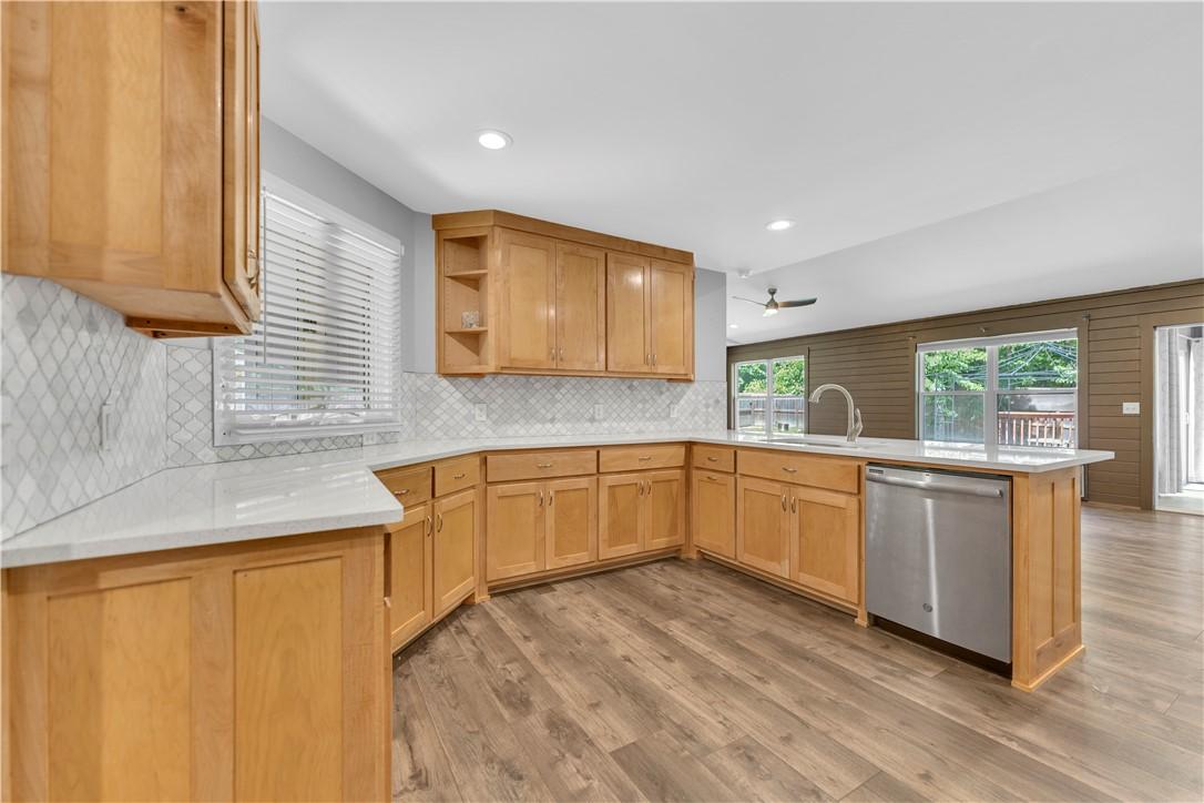 Image 4: Spacious kitchen featuring light wood cabinetry, w