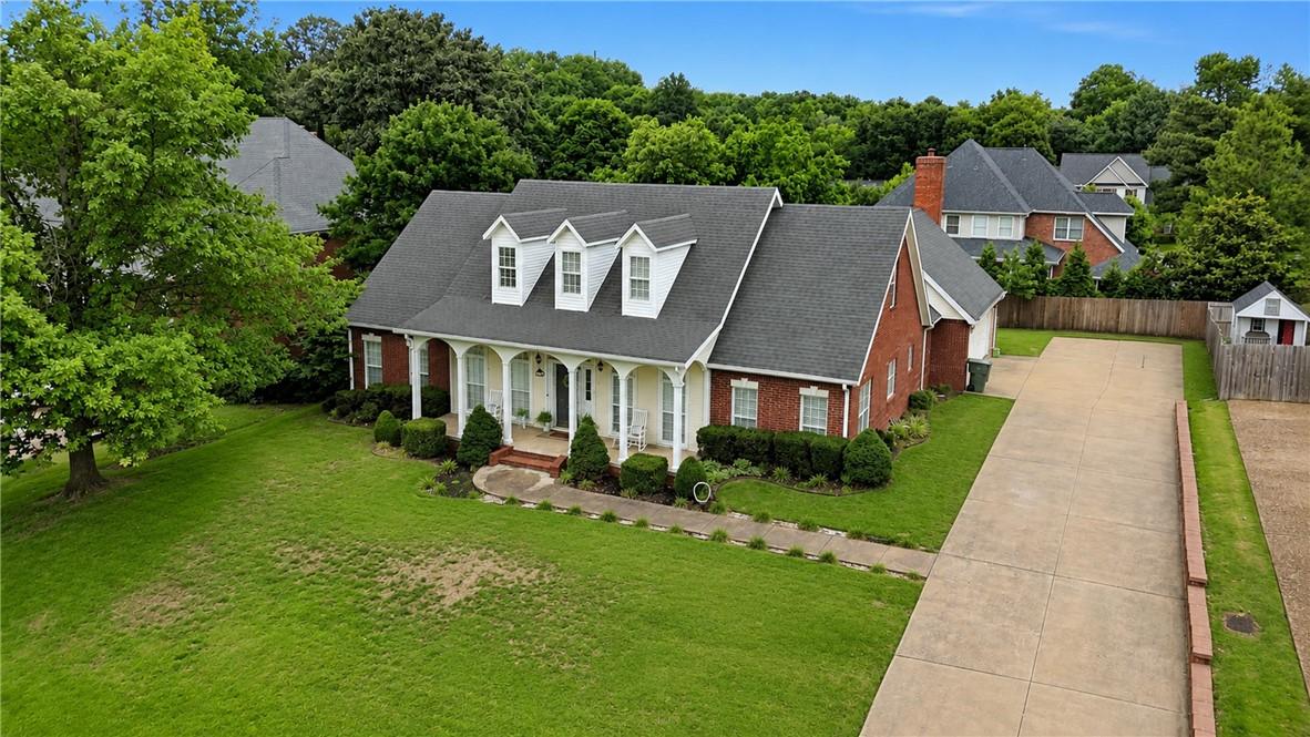 Image 4: Brick facade residence featuring a covered front p