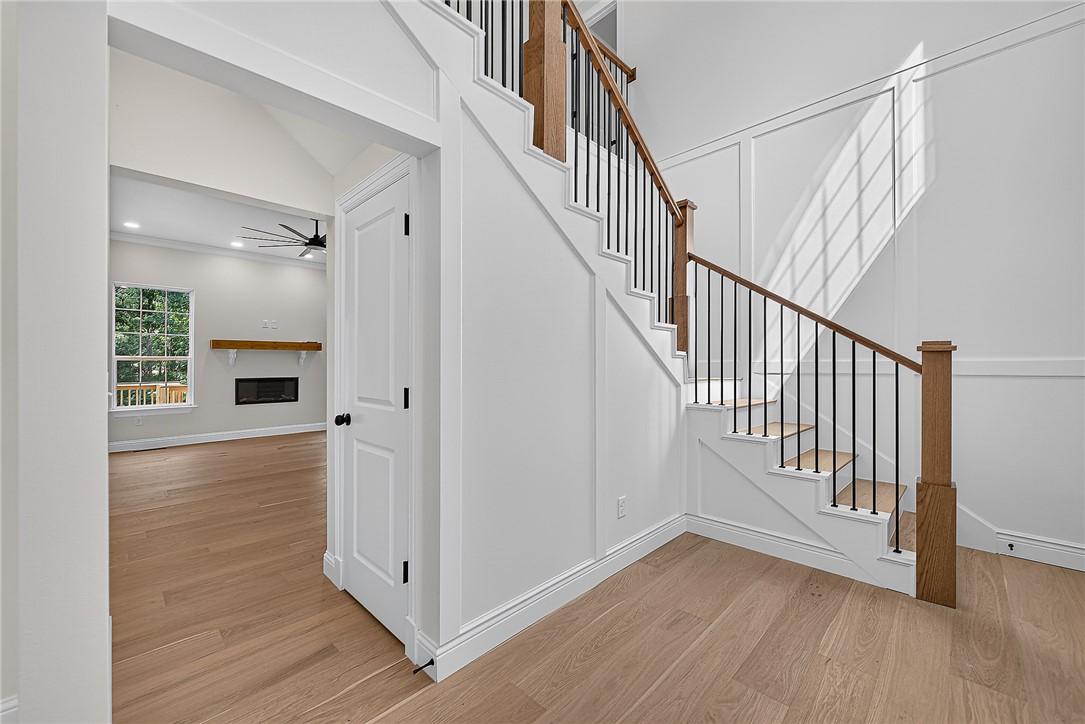 Image 3: Hardwood flooring throughout, a staircase with woo