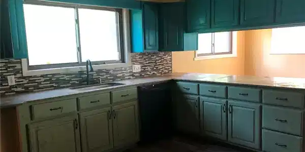 Image 2: Kitchen featuring a dual-basin sink, mosaic tile b