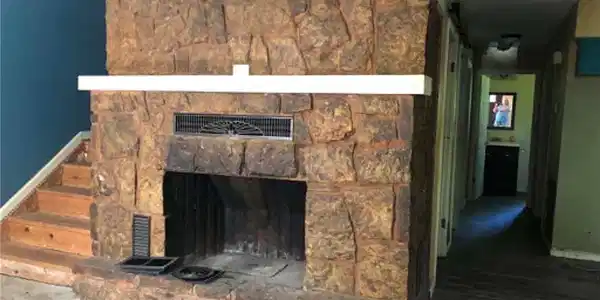 Image 3: Stone-clad fireplace with a white mantel, dark fir