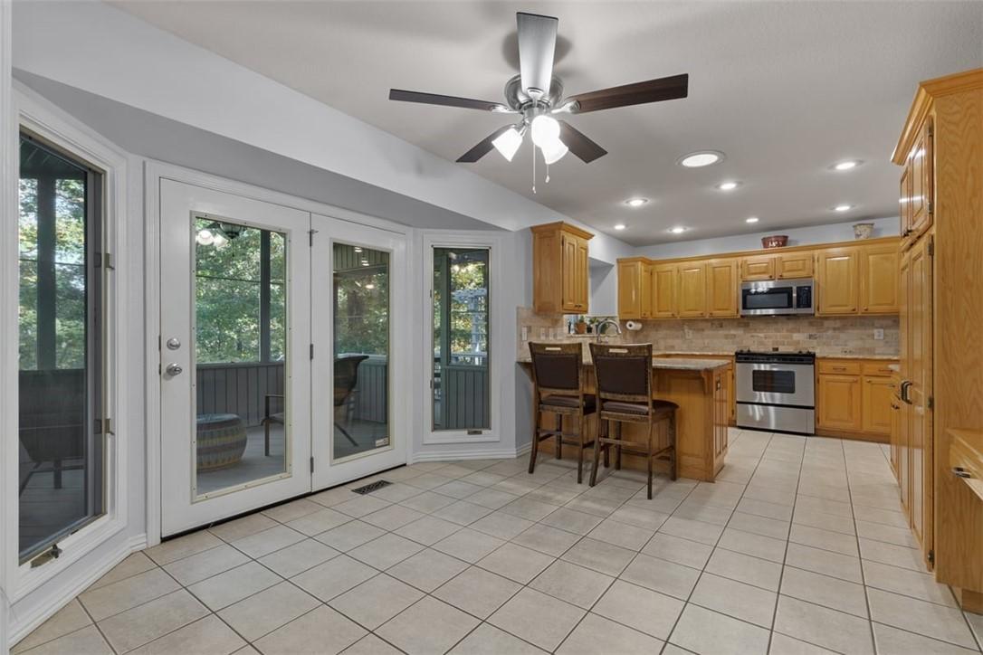 Image 3: Breakfast area leading to screened in  porch