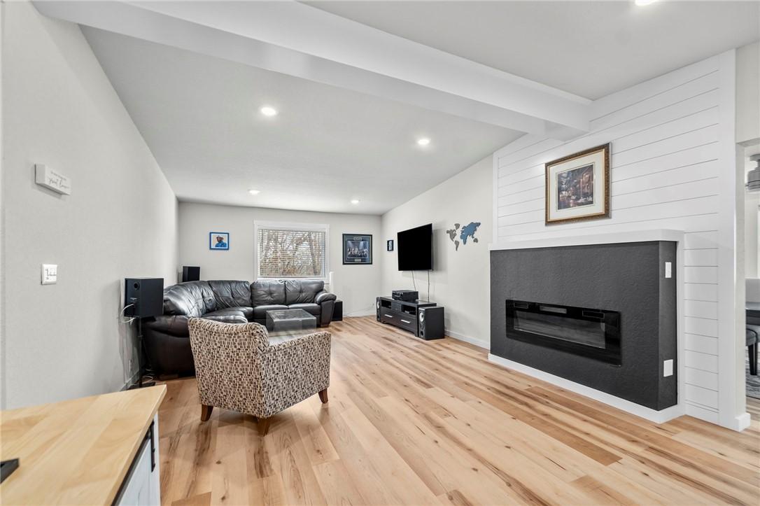 Image 3: Living room featuring beamed ceiling, a glass cove