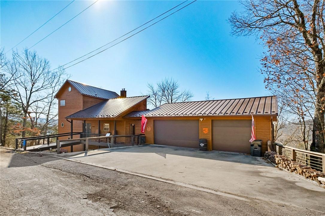 Image 2: Chalet / cabin featuring a garage, a standing seam