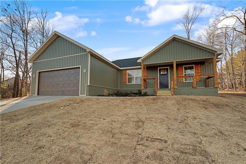 Image 1: Ranch-style house with covered porch, concrete dri