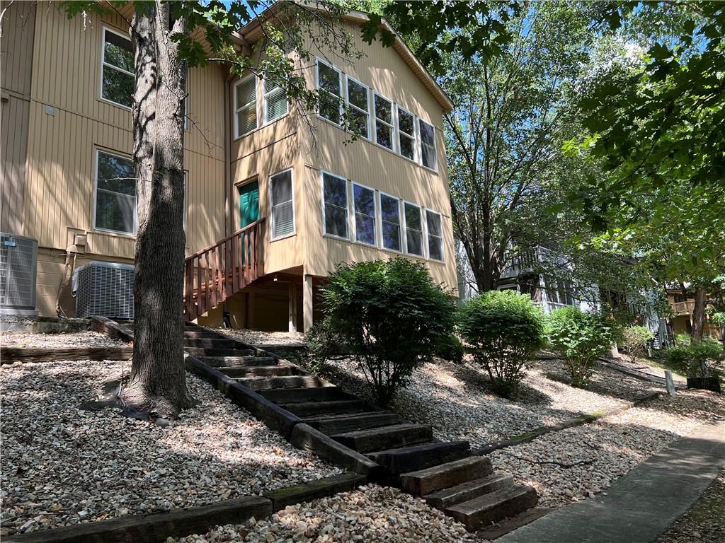 Image 3: Mature trees offer a shaded walk on the neighborho