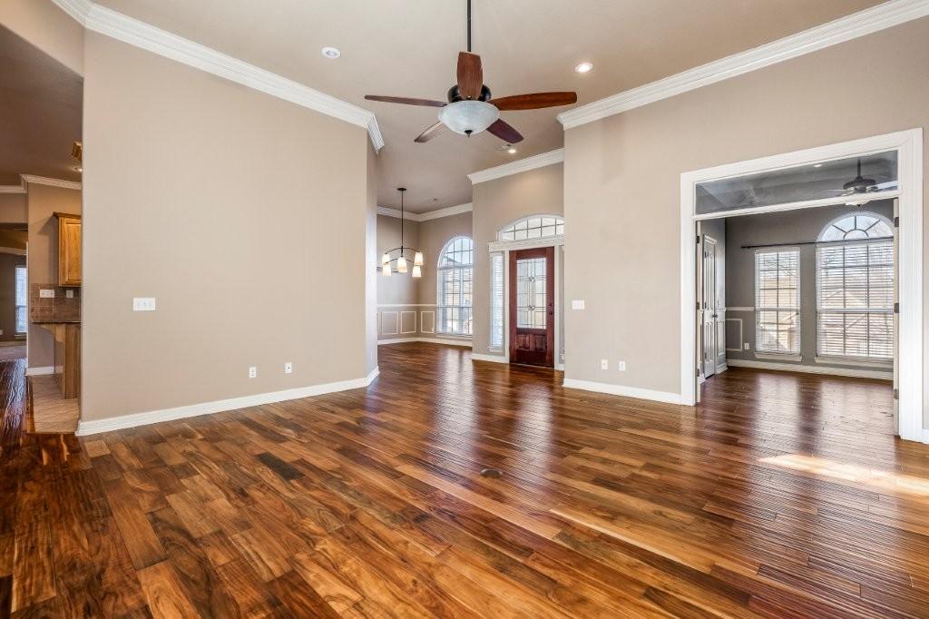 Image 4: Unfurnished living room with a ceiling fan, dark w