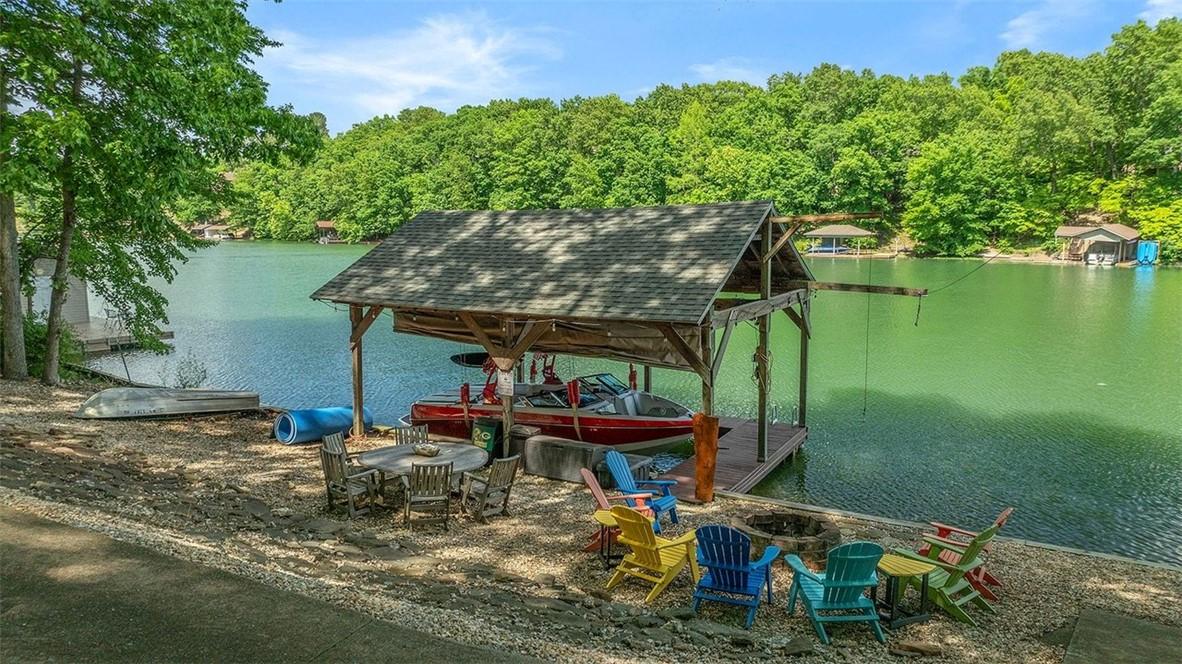 Image 1: Waterfront property featuring a private covered bo