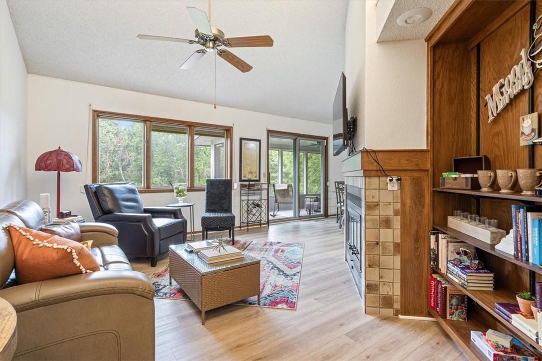 Image 3: Living room with gas log fireplace.  Large windows