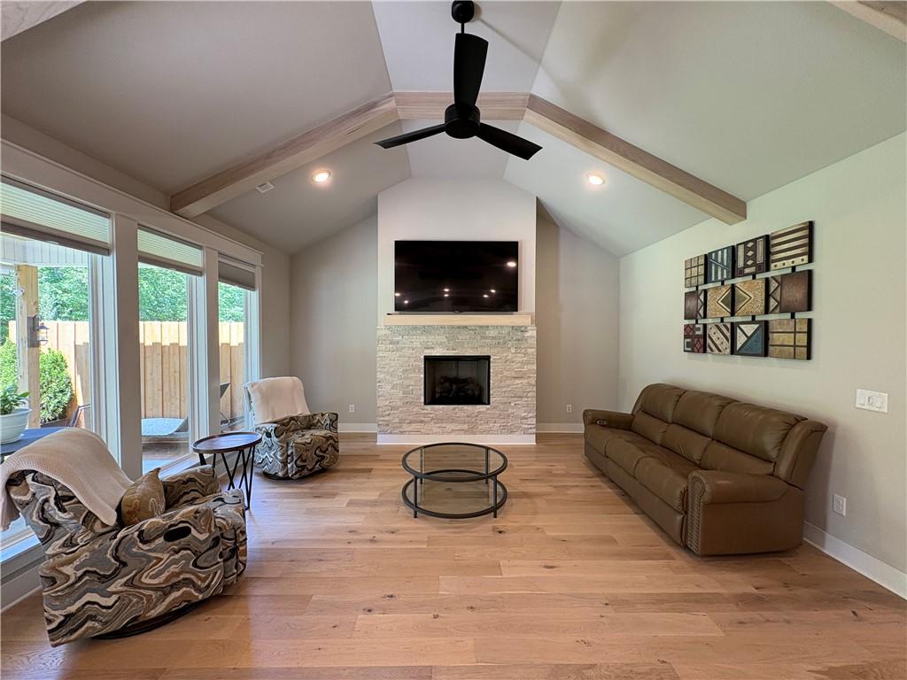 Image 3: Spacious living area featuring a vaulted ceiling w