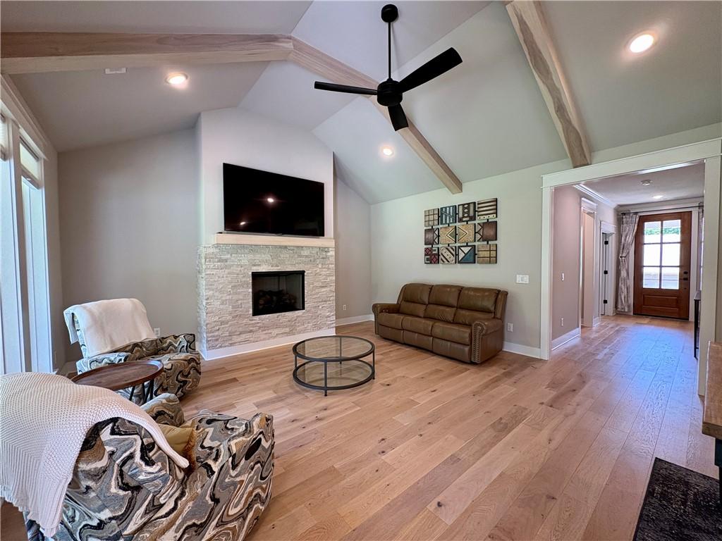 Image 4: Spacious living area featuring vaulted ceilings wi