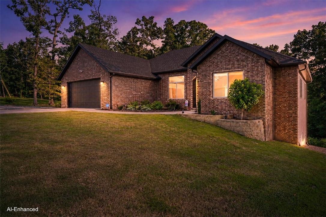 Image 1: Brick exterior featuring an attached garage with a