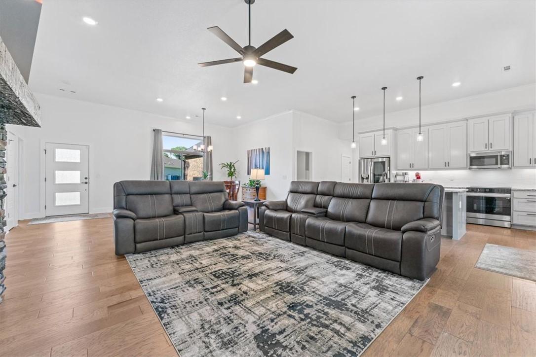 Image 4: Open-concept living area featuring wood-finish flo
