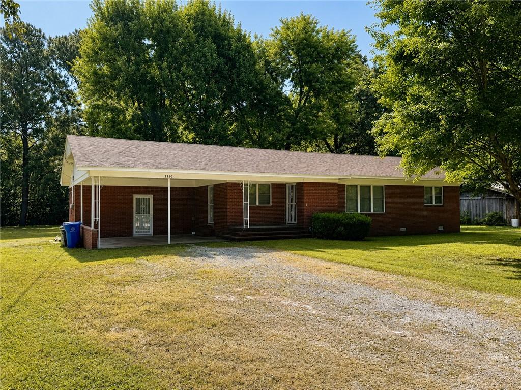 Image 2: Brick ranch-style residence featuring a carport an