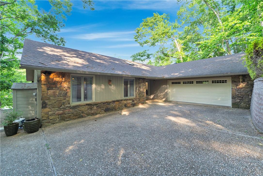 Image 2: Stone and siding exterior with a two-car garage
