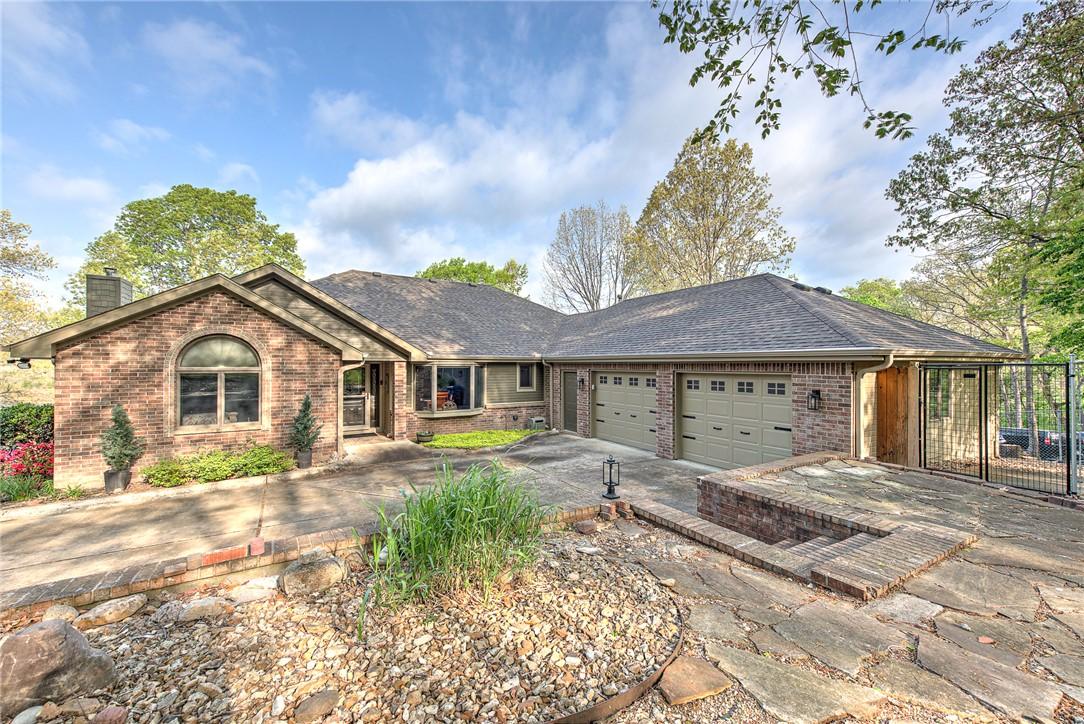 Image 1: The property features a brick exterior, an extra d