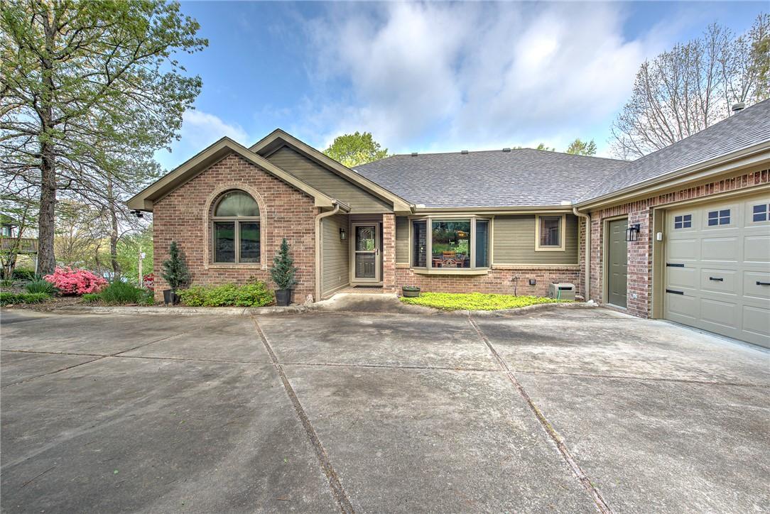 Image 4: The property features a brick and siding exterior,