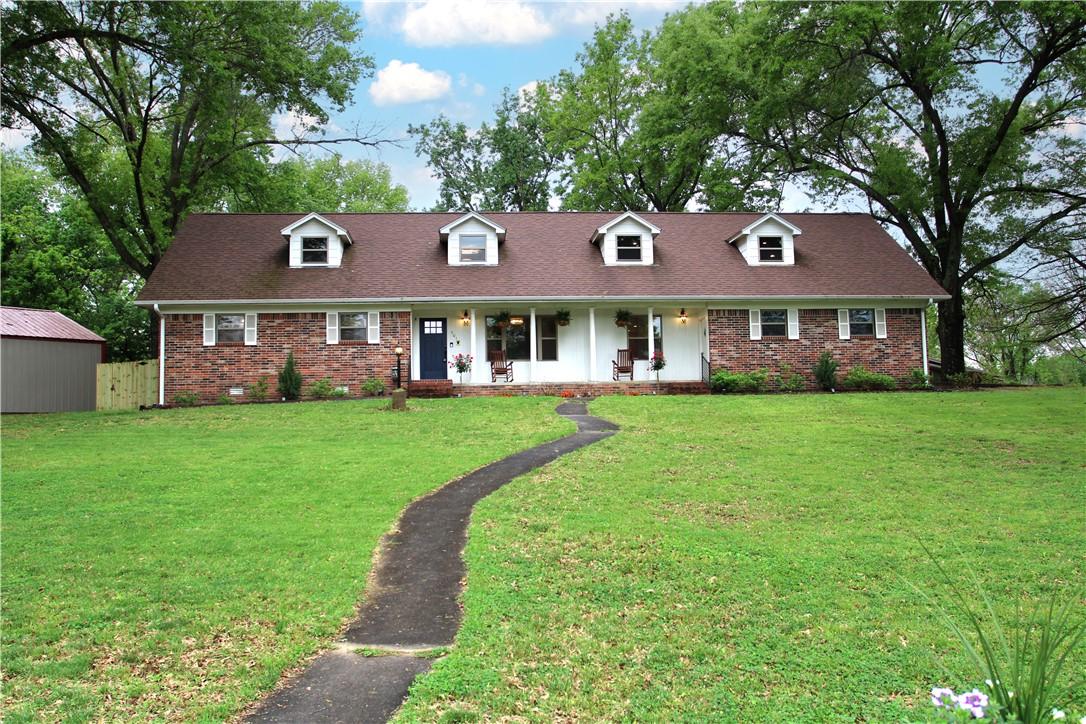 Image 2: This property features a brick exterior with white
