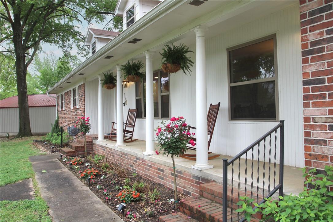 Image 3: The property features a charming front porch with