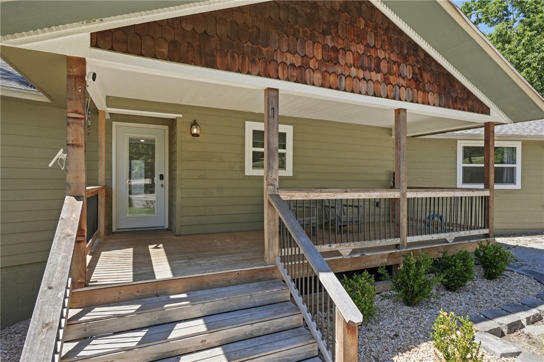 Image 3: Covered wood deck with natural wood posts and rail