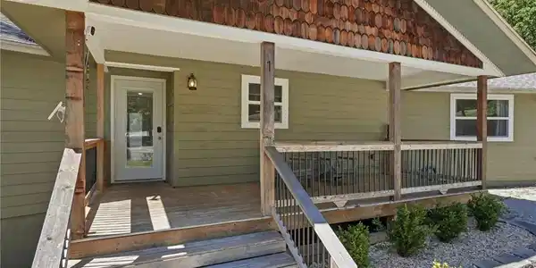Image 3: Covered wood deck with natural wood posts and rail