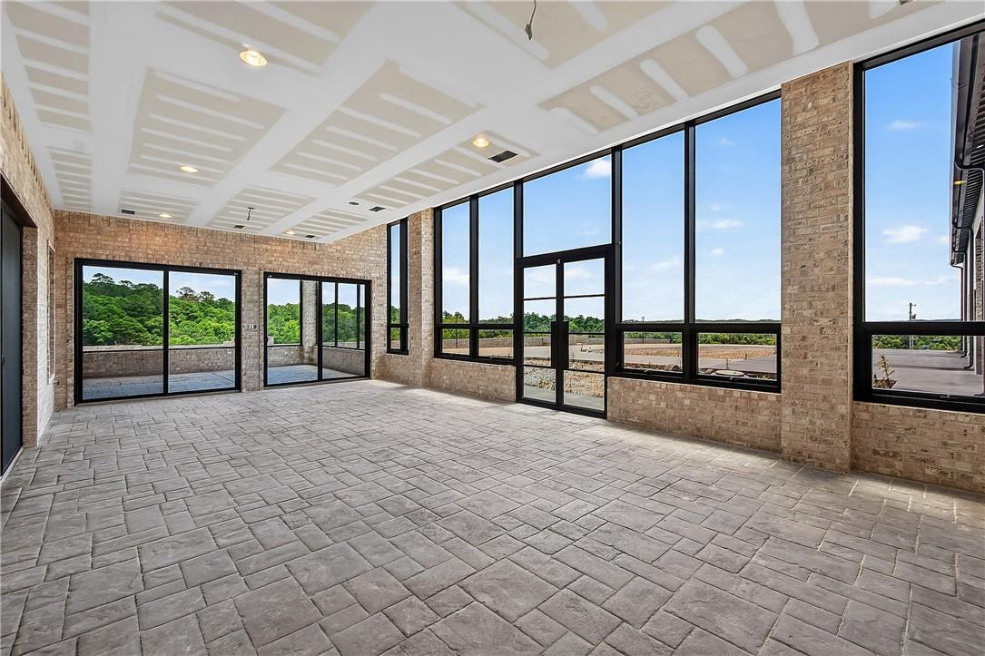 Image 4: Spacious room featuring floor-to-ceiling windows,
