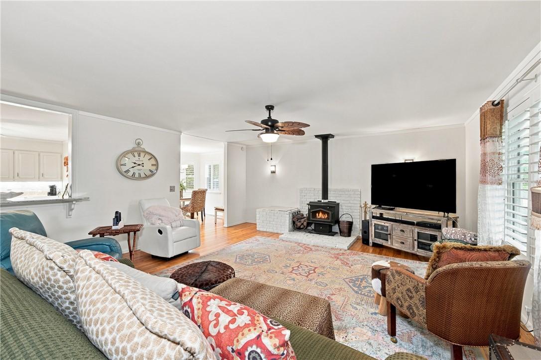 Image 2: Living area featuring a wood-burning stove with a