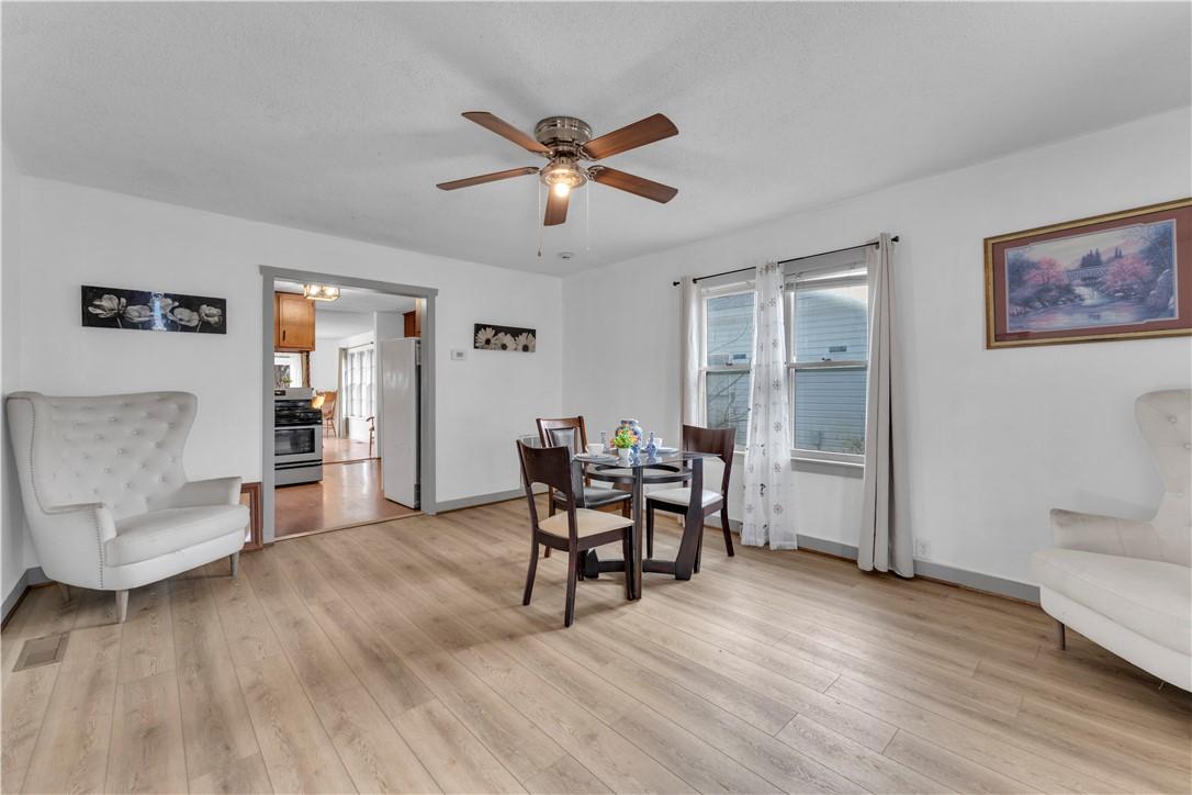 Image 2: Dining space featuring ceiling fan and light wood