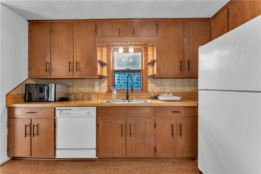 Image 4: Kitchen with white appliances, light countertops,