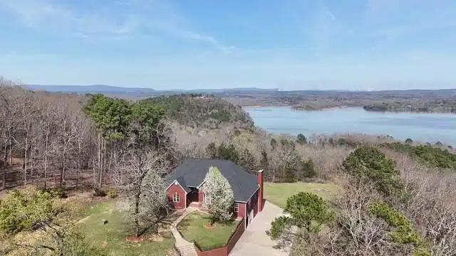 Image 1: Aerial view of a nearby body of water and a heavil