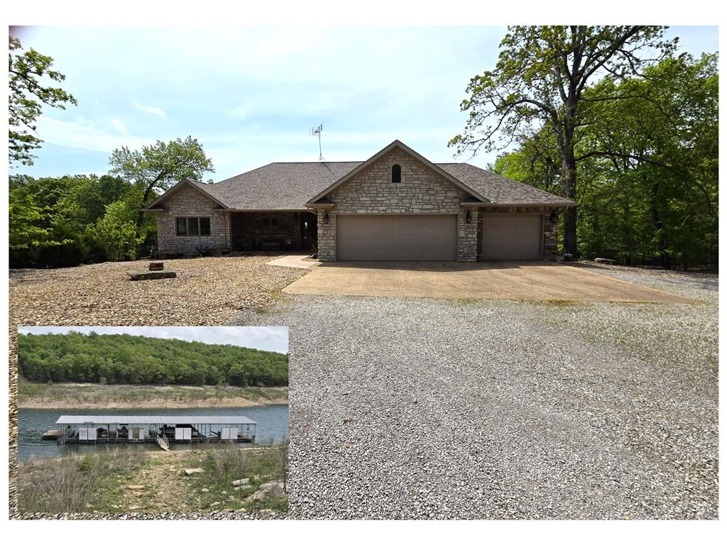 Image 1: Stone veneer exterior with an attached two-car gar