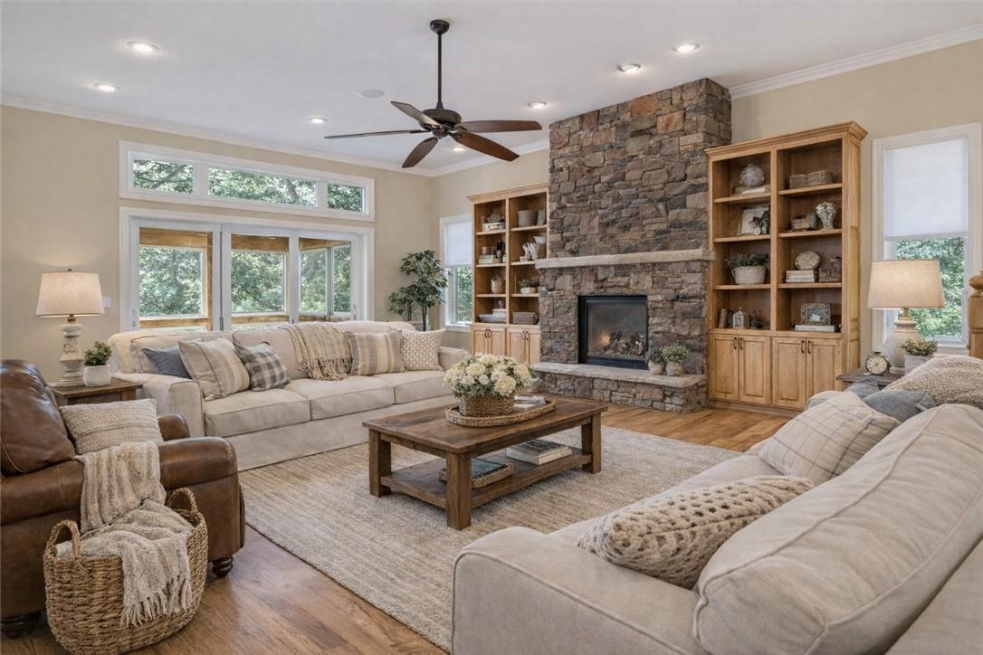 Image 4: Living room featuring wood finished floors, crown