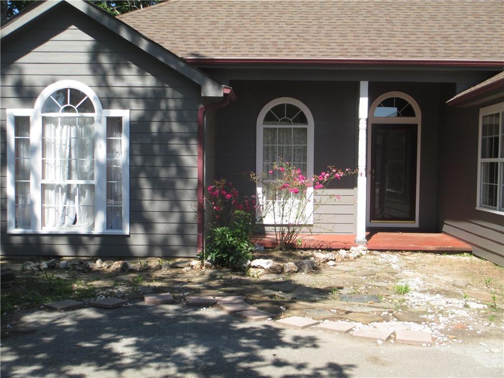 Image 3: Gray horizontal siding exterior with white arched