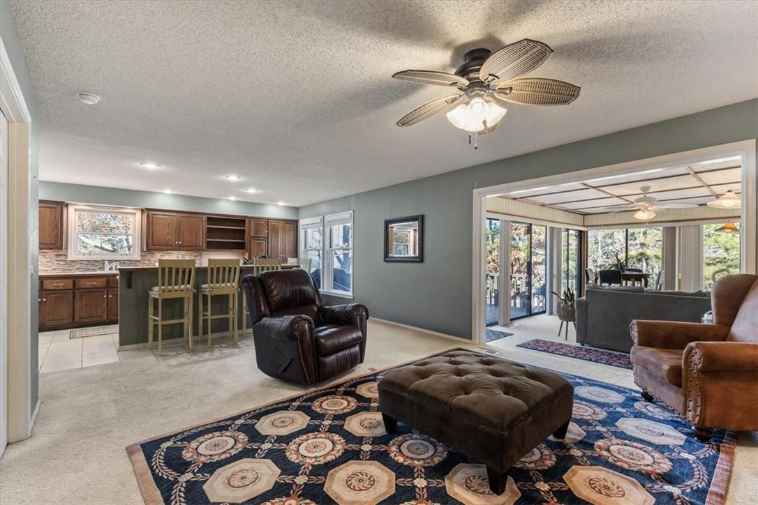 Image 2: Living area featuring light colored carpet, a text