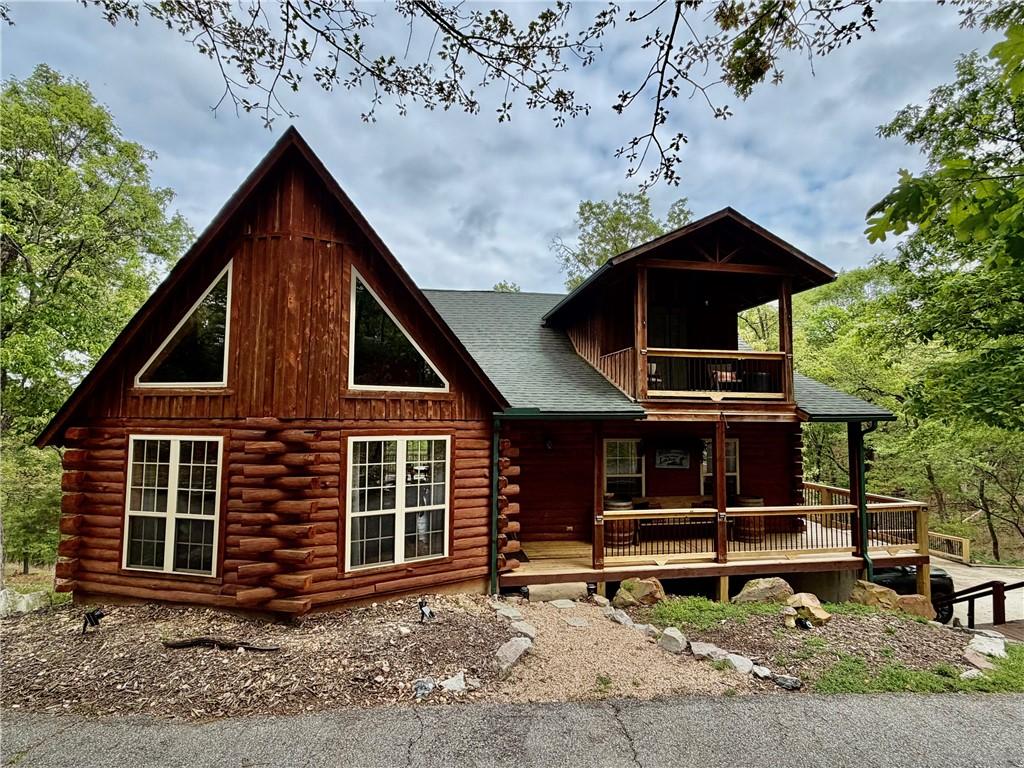 Image 1: A charming log cabin property featuring a prominen