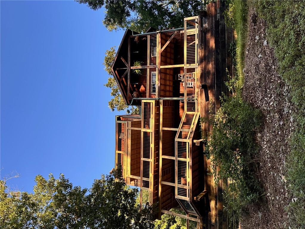 Image 2: The property features extensive wooden decking wit