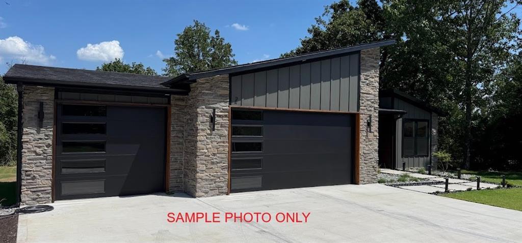 Image 3: Modern exterior featuring stone veneer siding, dar