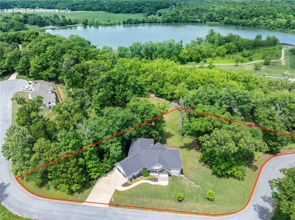 Image 2: Property featuring an extensive treed lot with a s