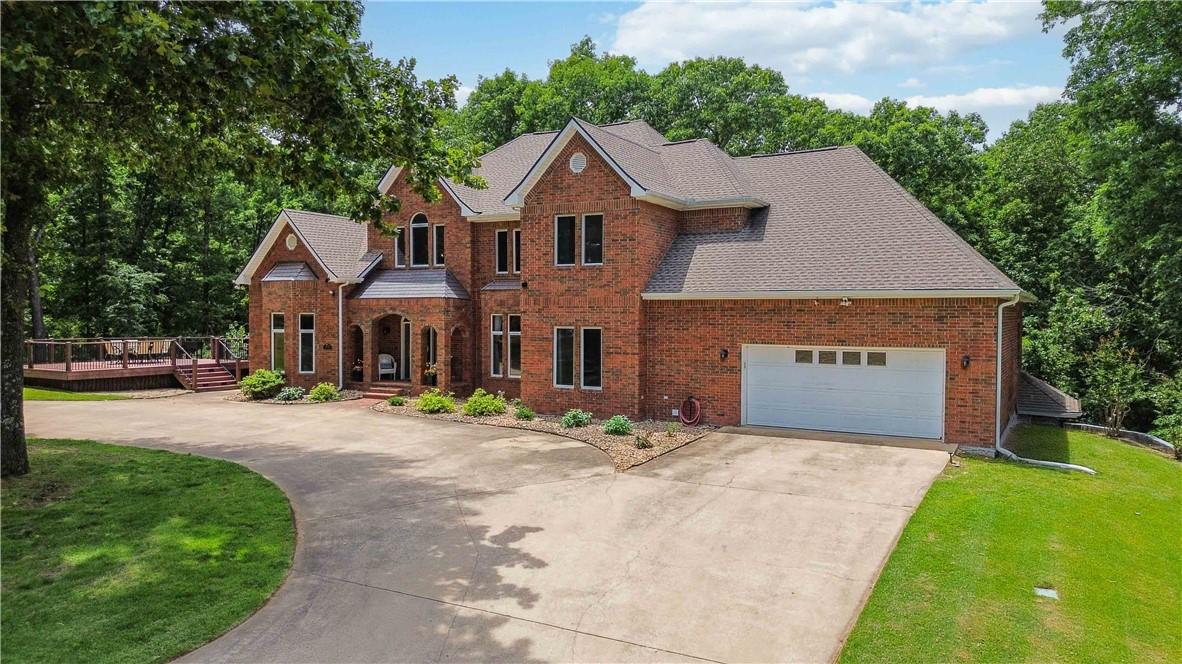 Image 2: Brick exterior residence with a multi-level roofli
