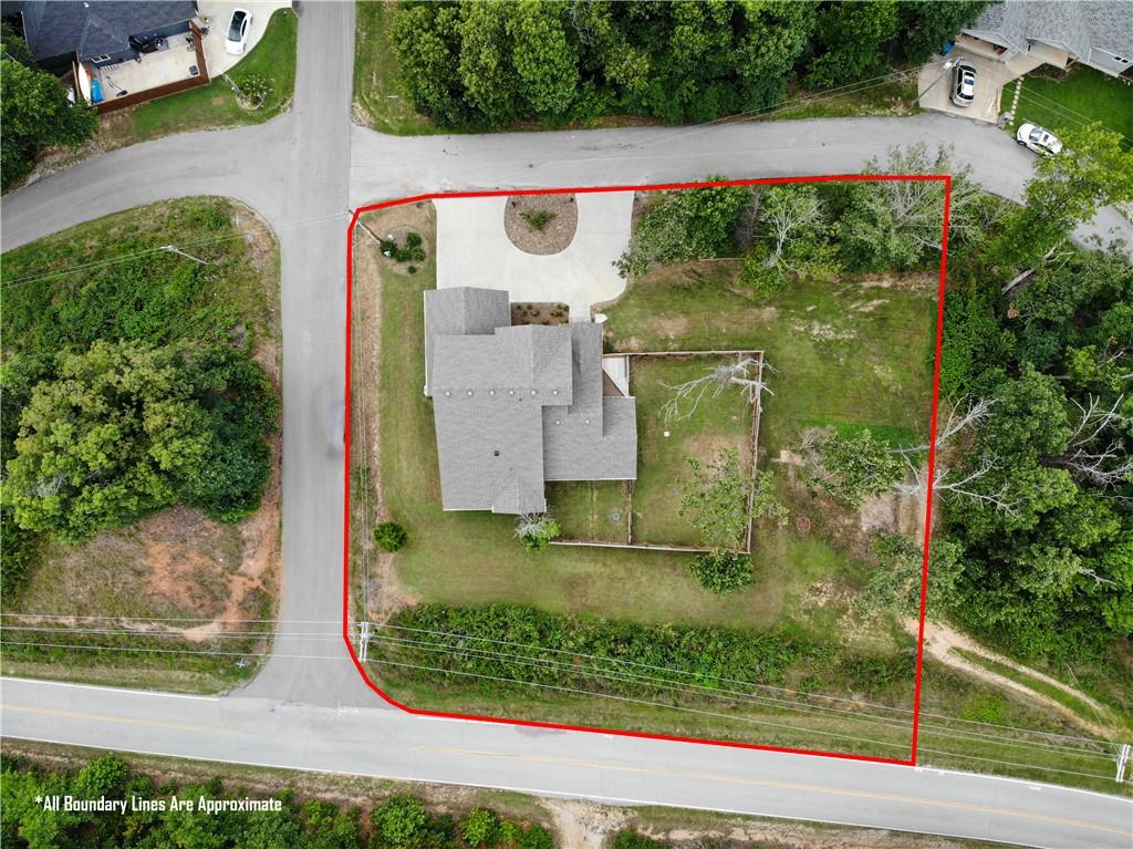 Image 2: Aerial perspective showcasing a property with a mu
