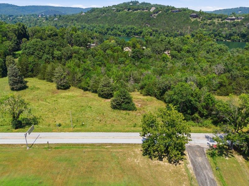 Image 3: Expansive land parcel featuring a paved road front
