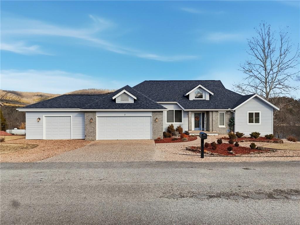 Image 2: View of front of house with driveway, a shingled r