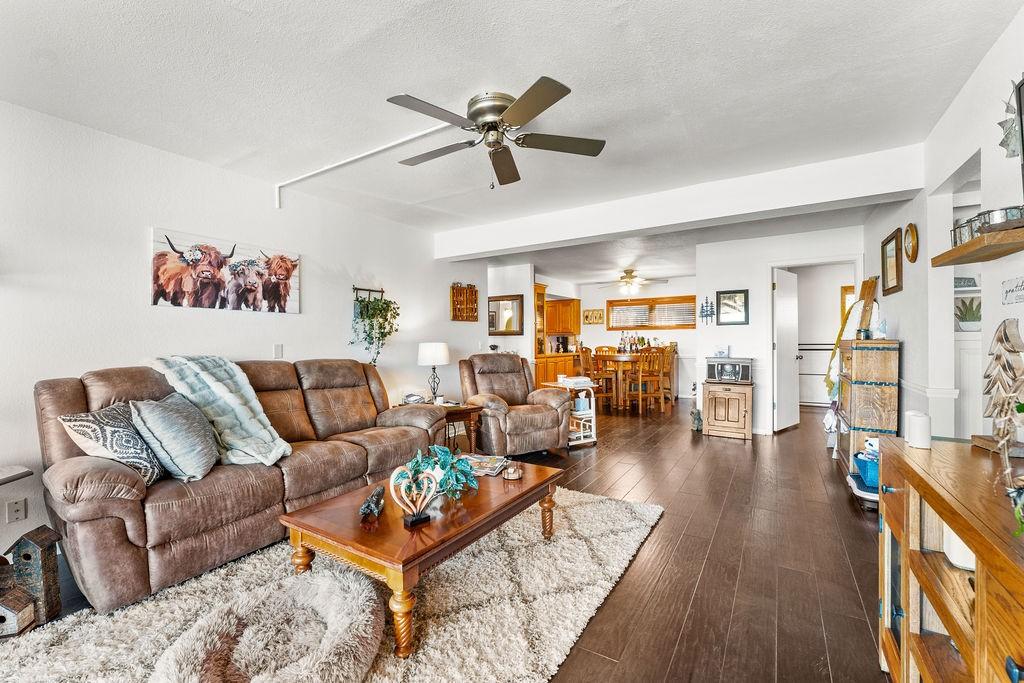 Image 4: Living room with dark wood finished floors, a ceil