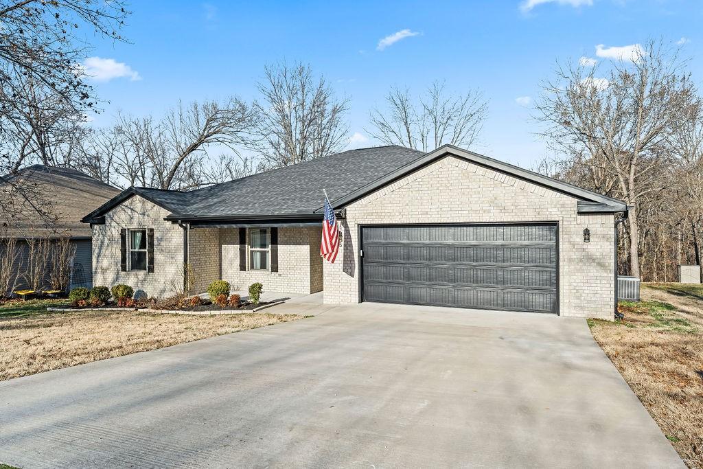 Image 2: Ranch-style house featuring concrete driveway, an